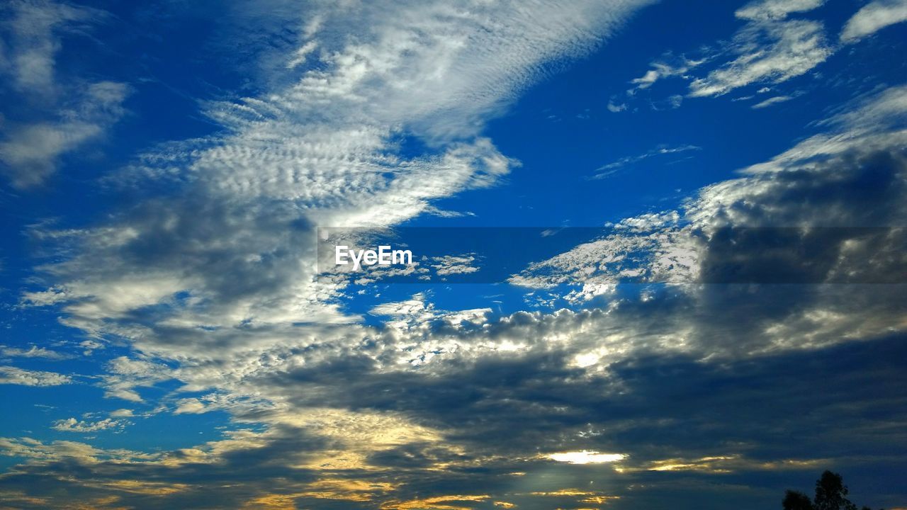 LOW ANGLE VIEW OF BLUE SKY AND CLOUDS IN BACKGROUND