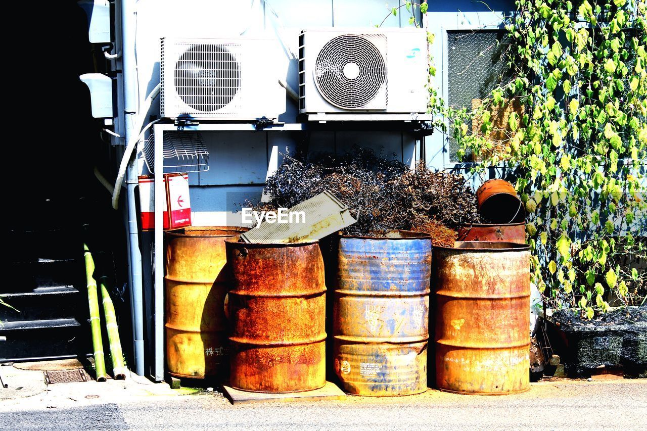 STACK OF POTTED PLANT BY METAL GRATE