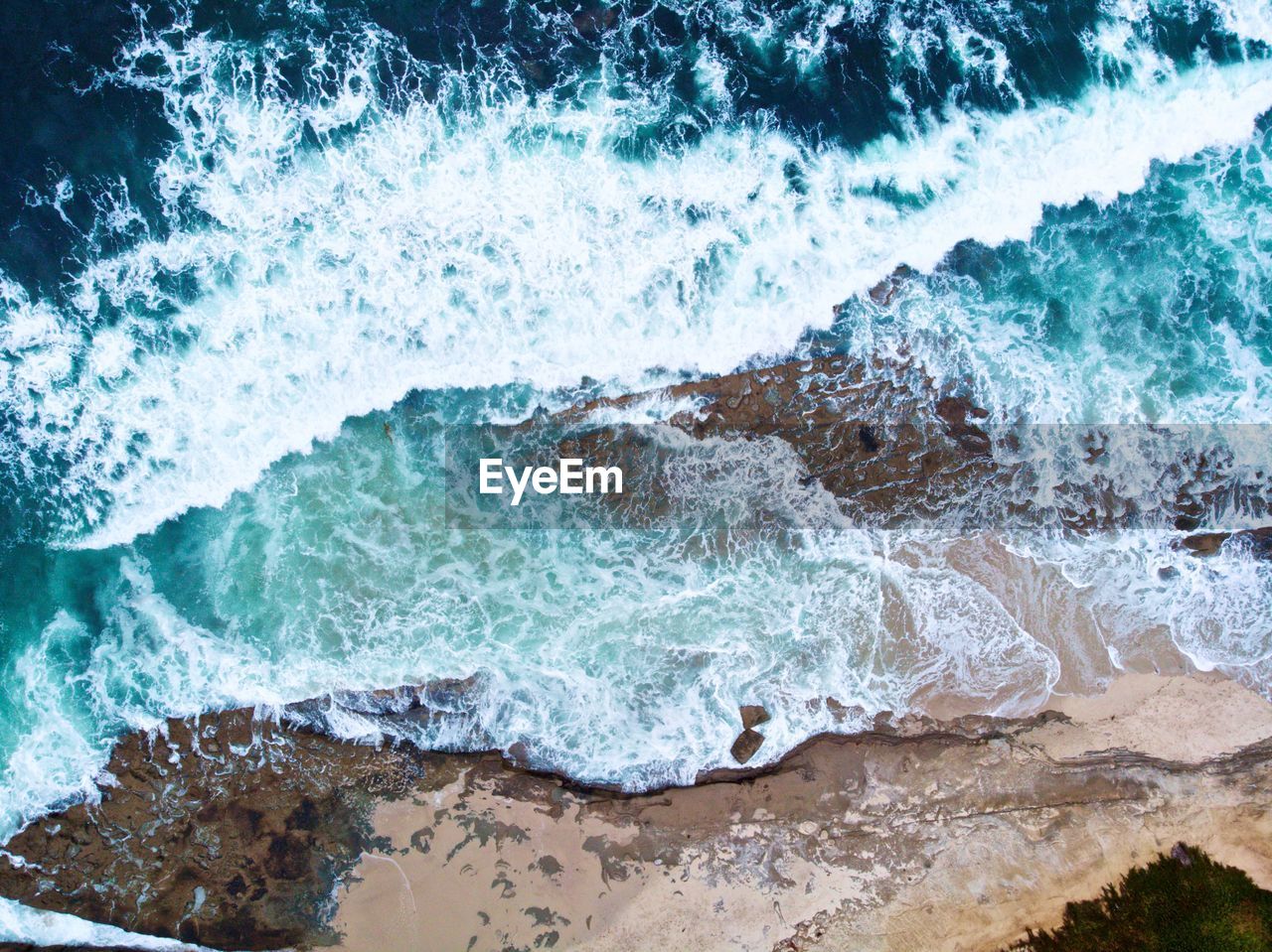 High angle view of waves splashing on shore