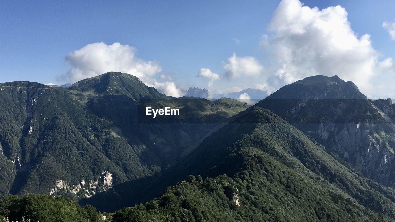 PANORAMIC VIEW OF MOUNTAIN RANGE AGAINST SKY