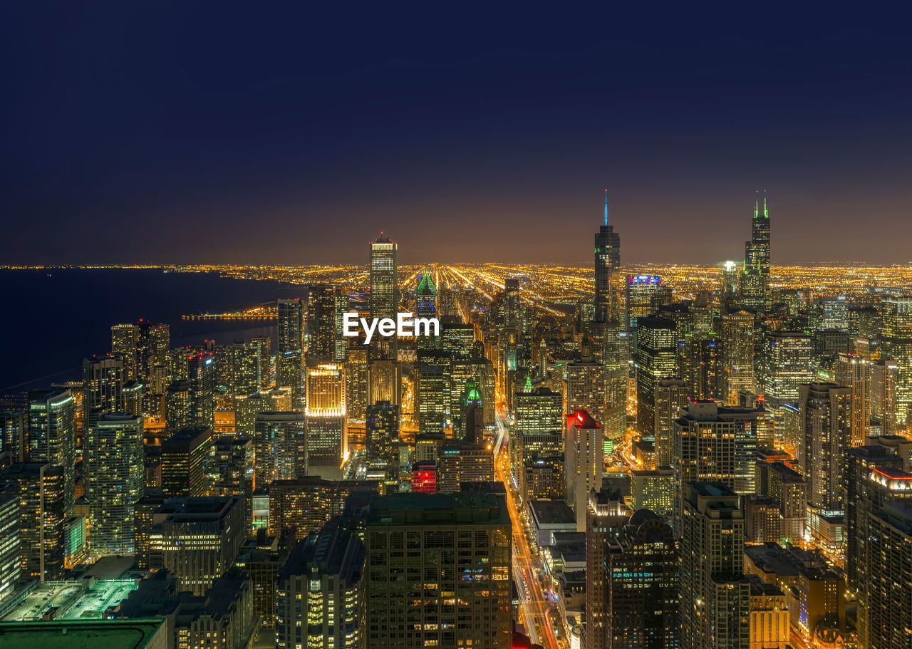 Aerial view of city lit up at night