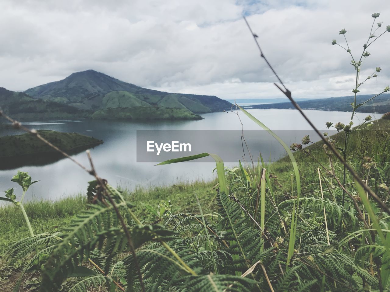 Scenic view of lake and mountains against sky