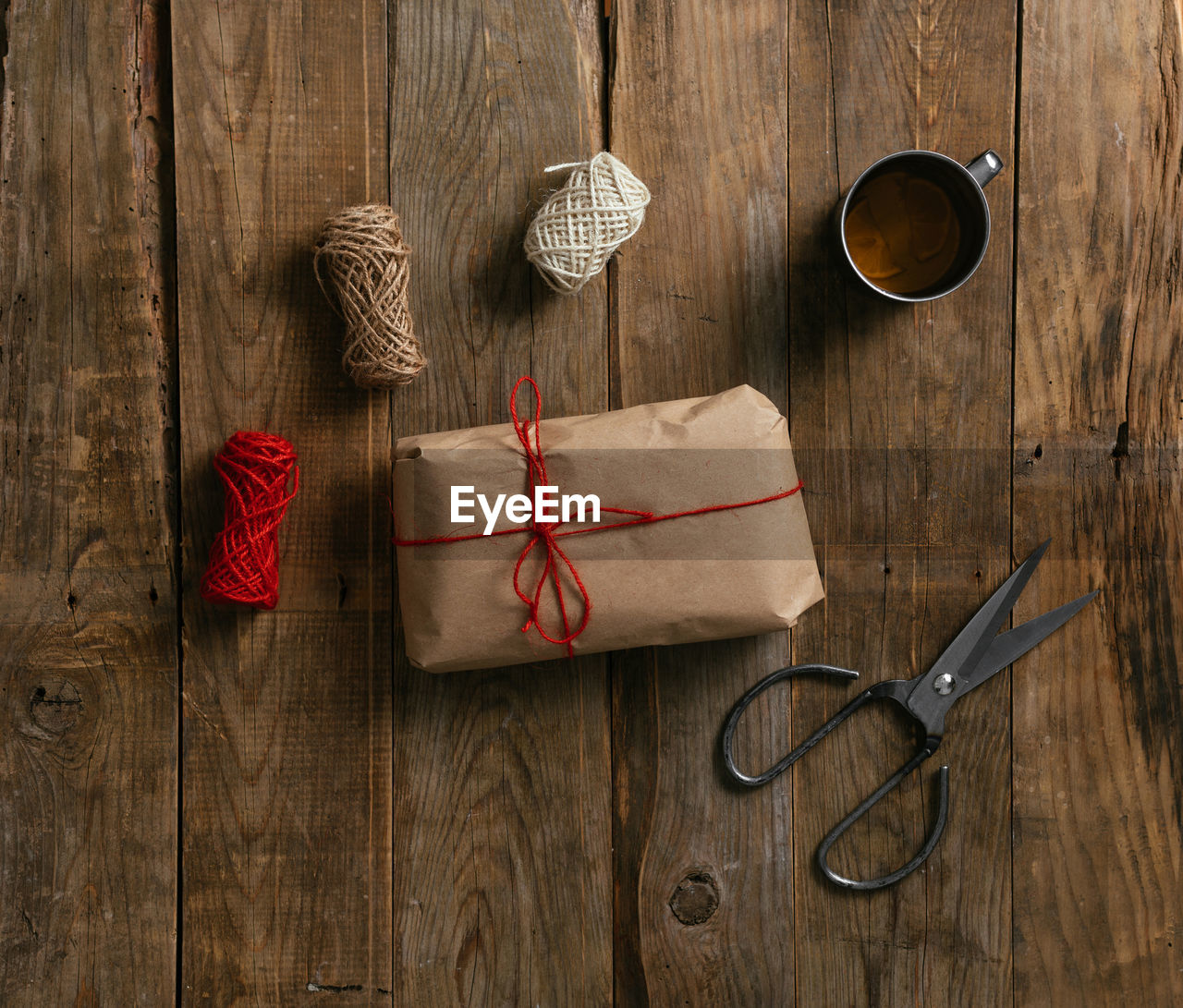 Top view of packing a gift on a wooden table