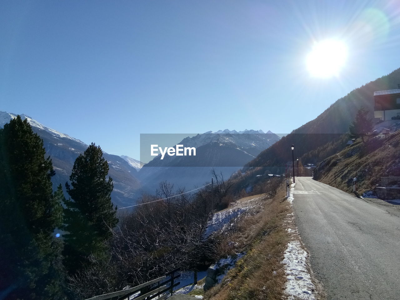 ROAD AMIDST SNOWCAPPED MOUNTAINS AGAINST SKY