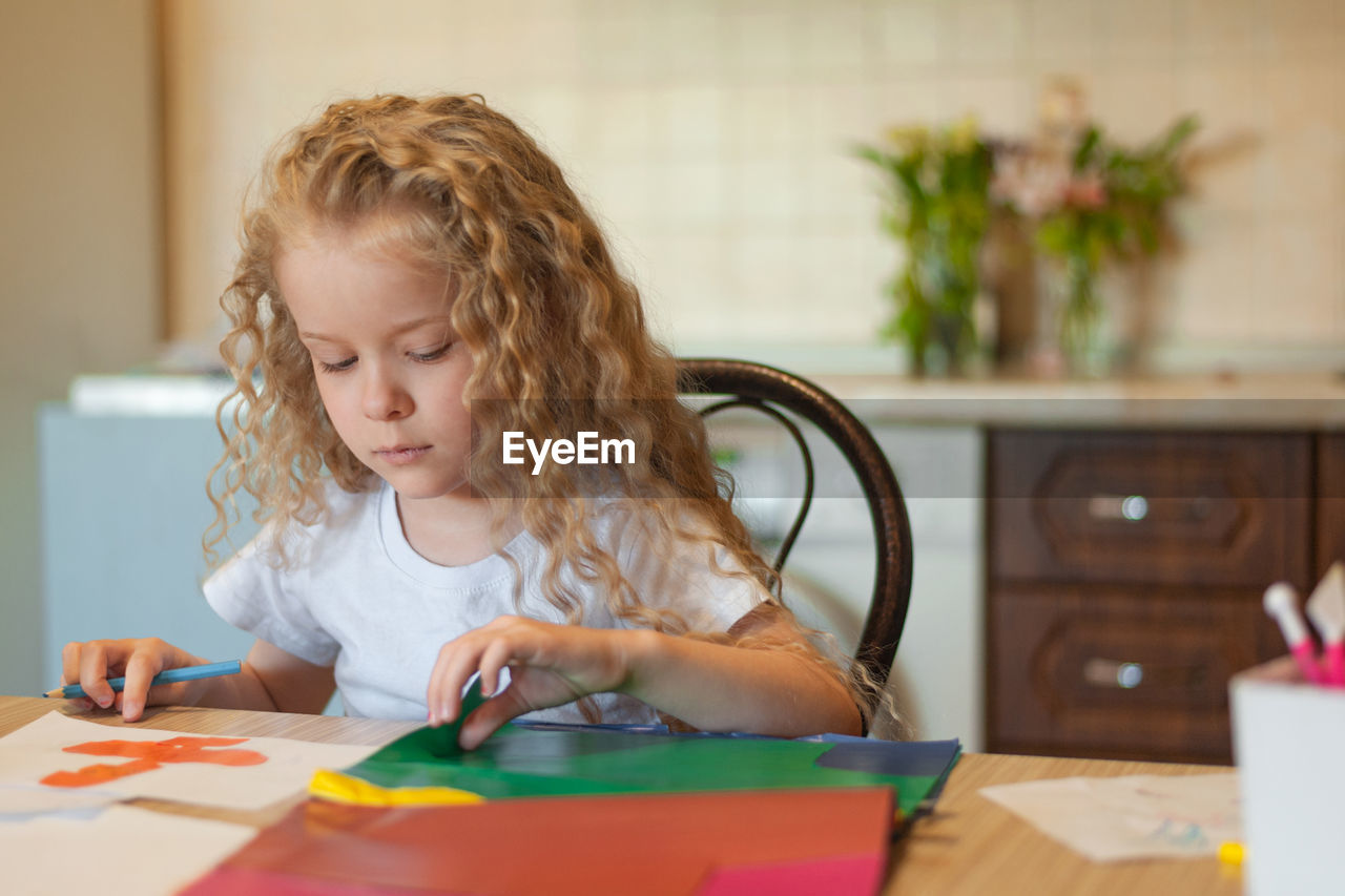 Girl doing craft while sitting at home