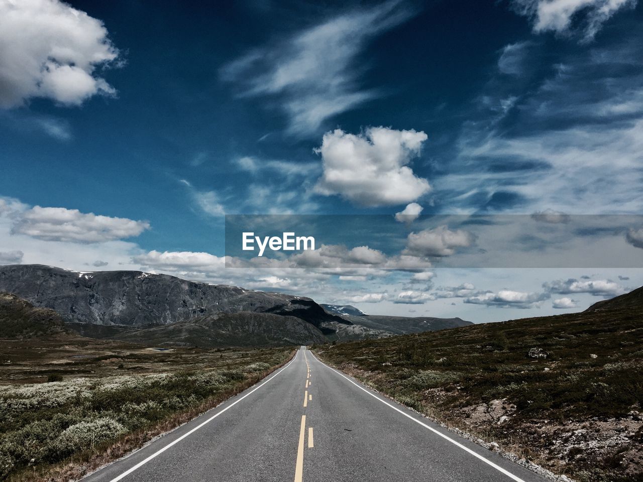 Road amidst landscape against sky