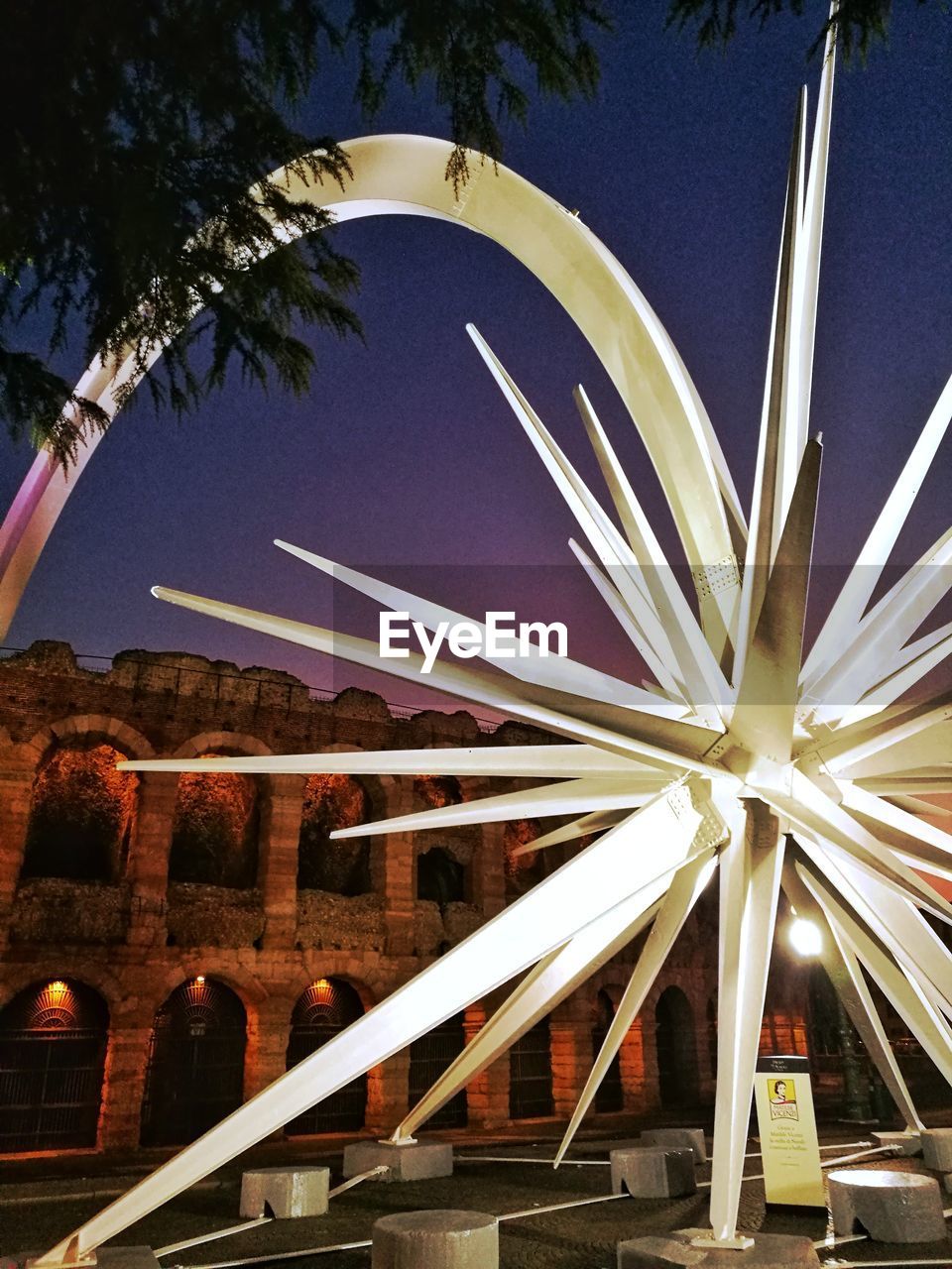 LOW ANGLE VIEW OF ILLUMINATED BUILDING AGAINST SKY