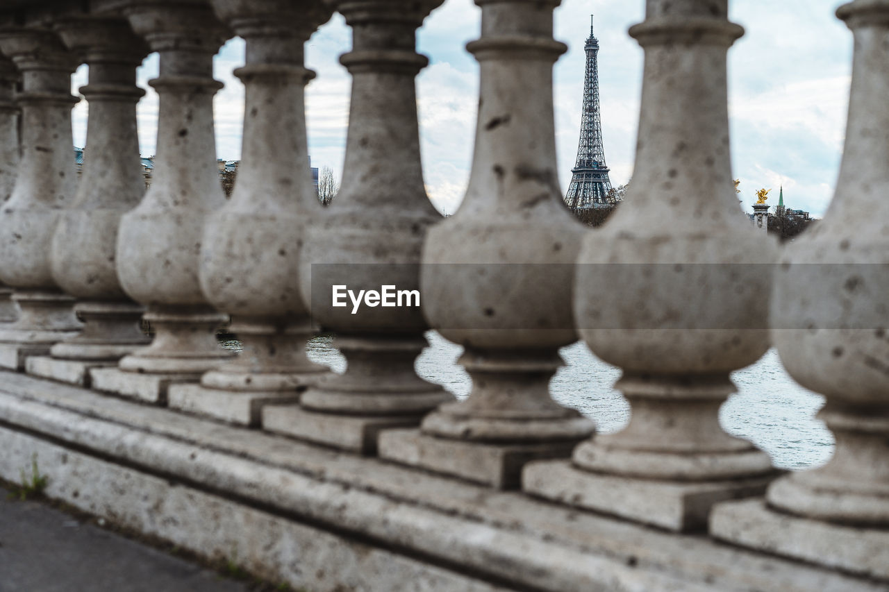 Eiffel tower seen though stone railing