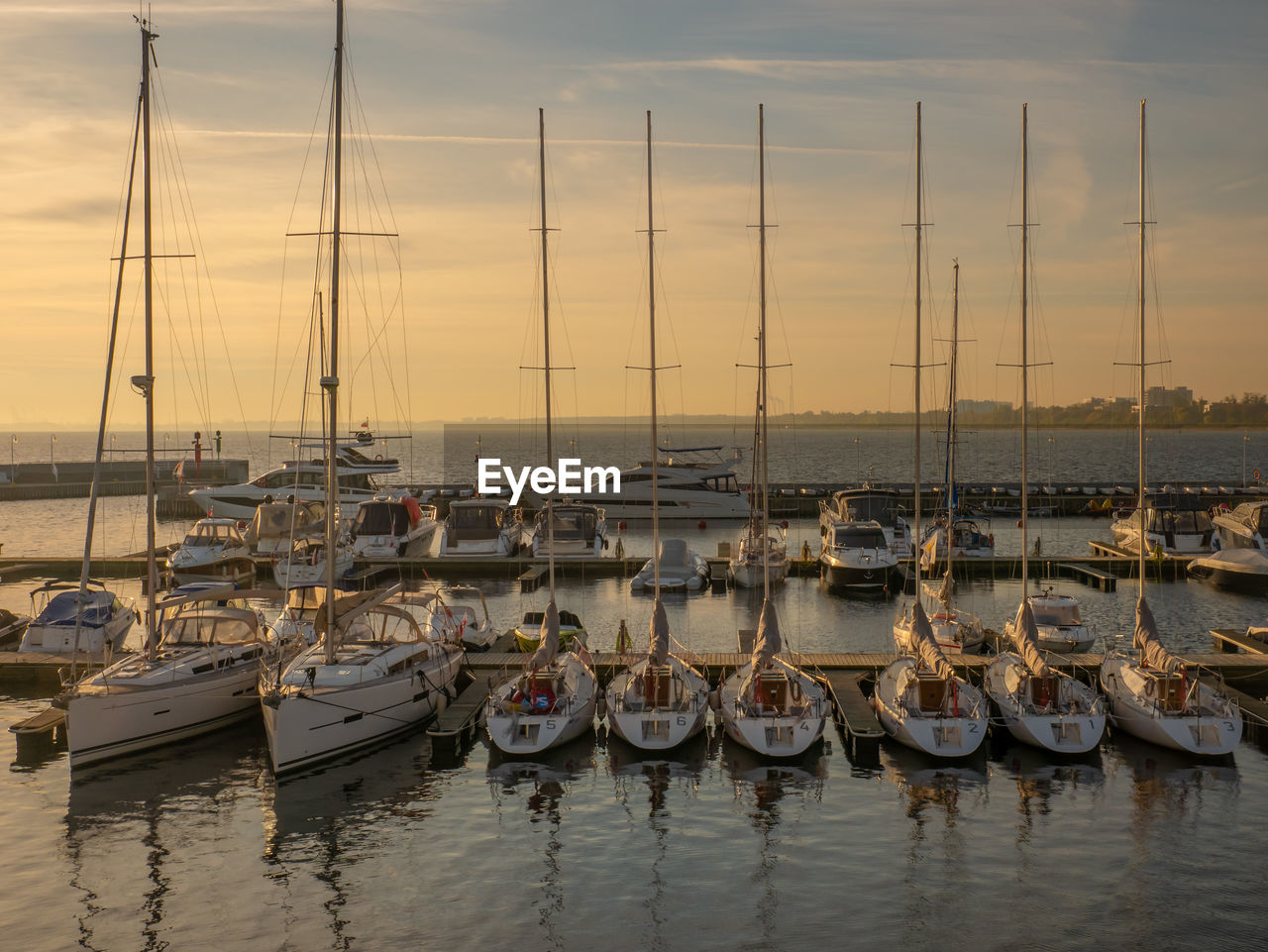 BOATS MOORED AT HARBOR