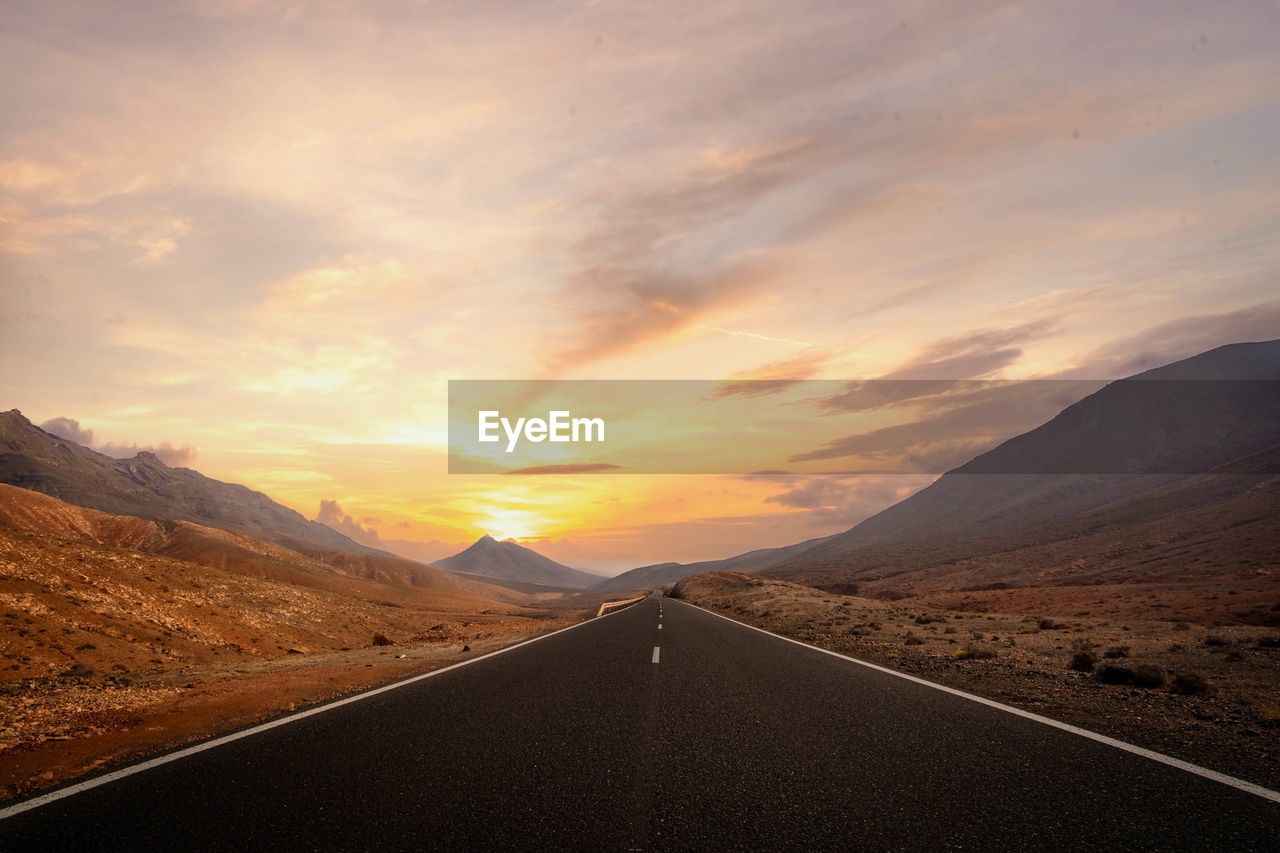 scenic view of desert against sky during sunset