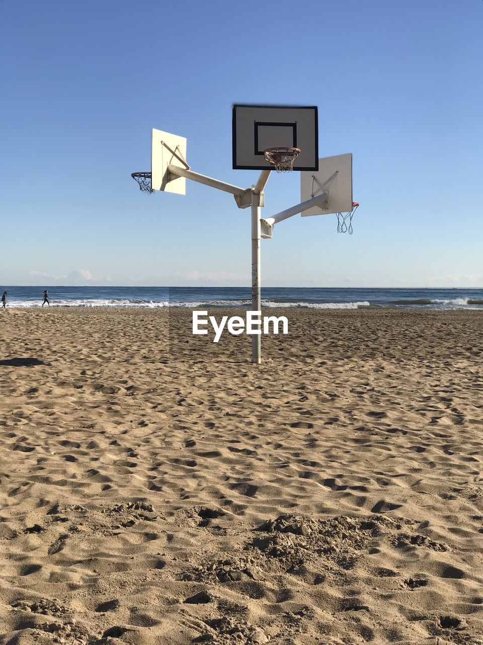 Basketball hut on beach against clear sky