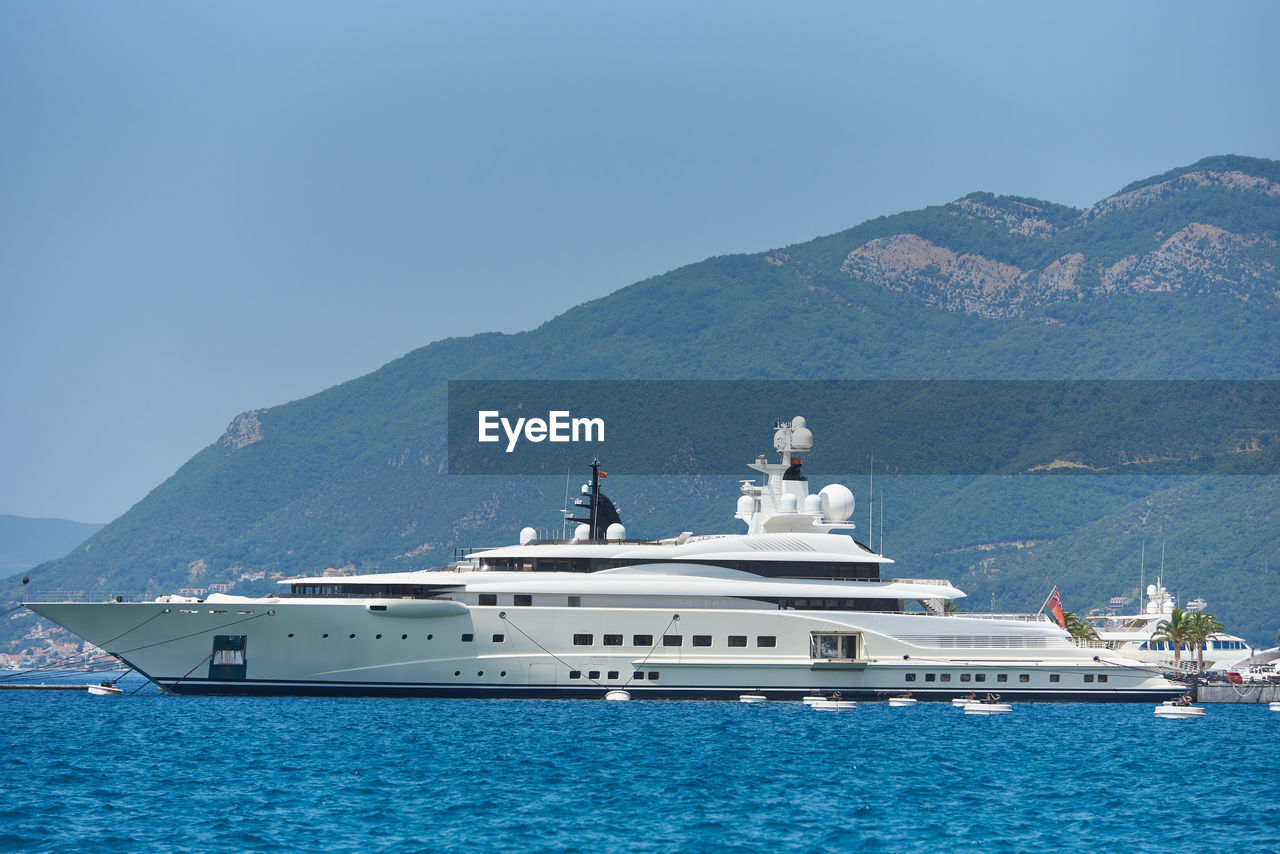 Luxury yacht is moored against the backdrop of mountains in montenegro