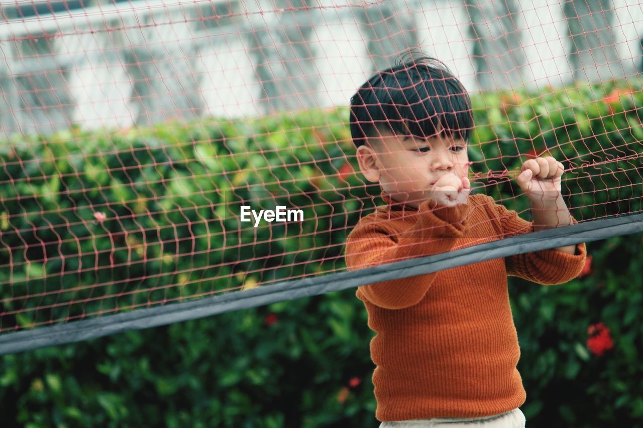 A child is playing with a badminton net