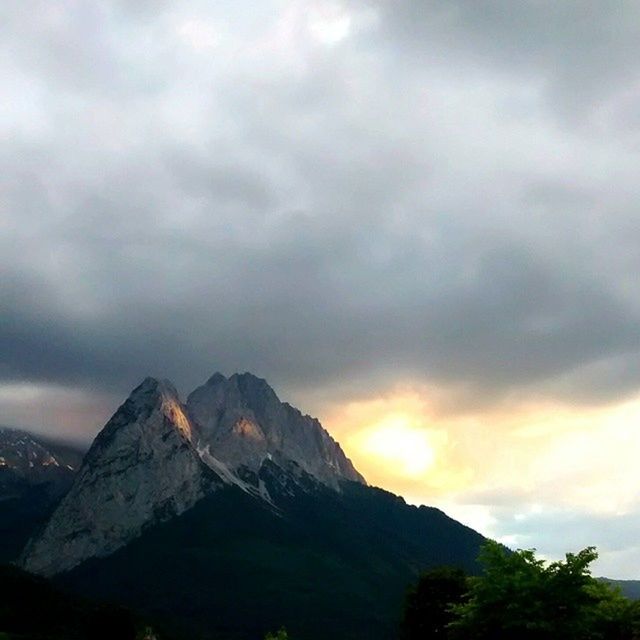 SCENIC VIEW OF MOUNTAINS AGAINST CLOUDY SKY