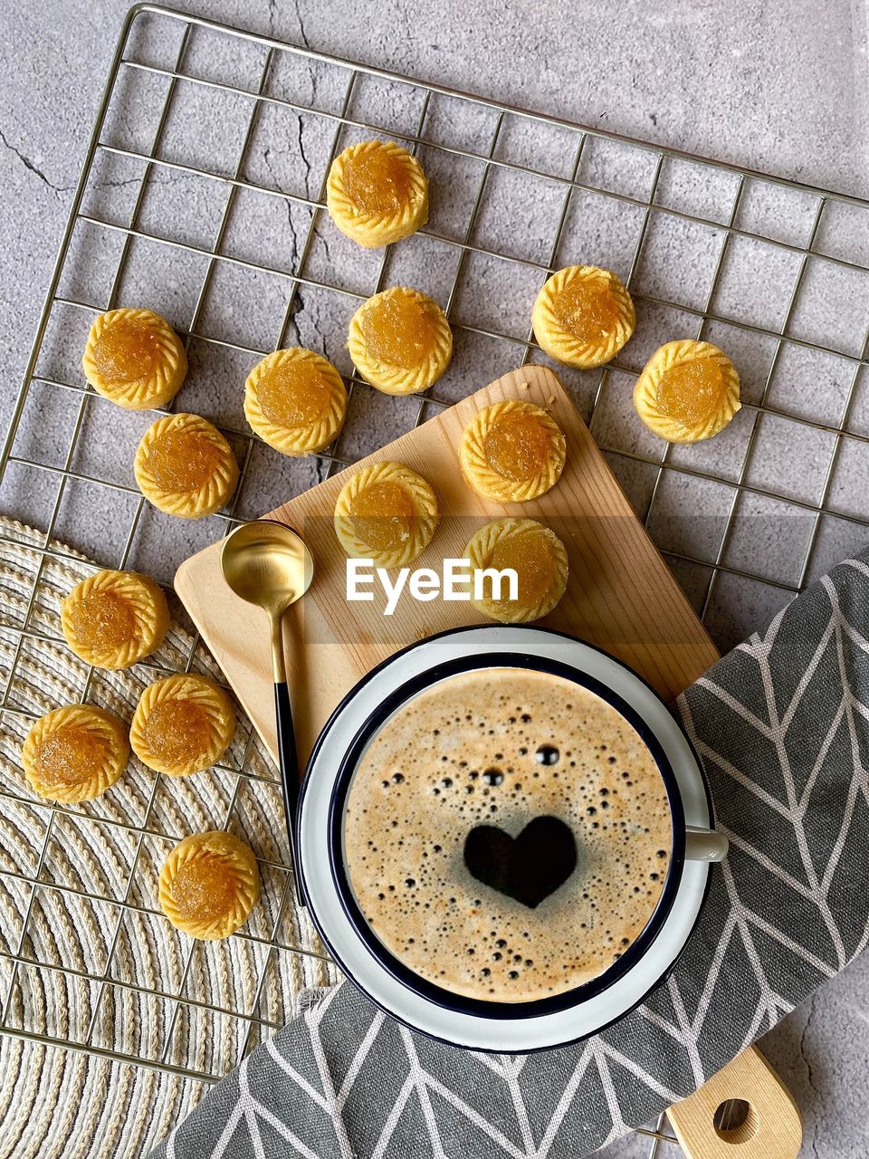 Pineapples tart cookies and black coffee on table