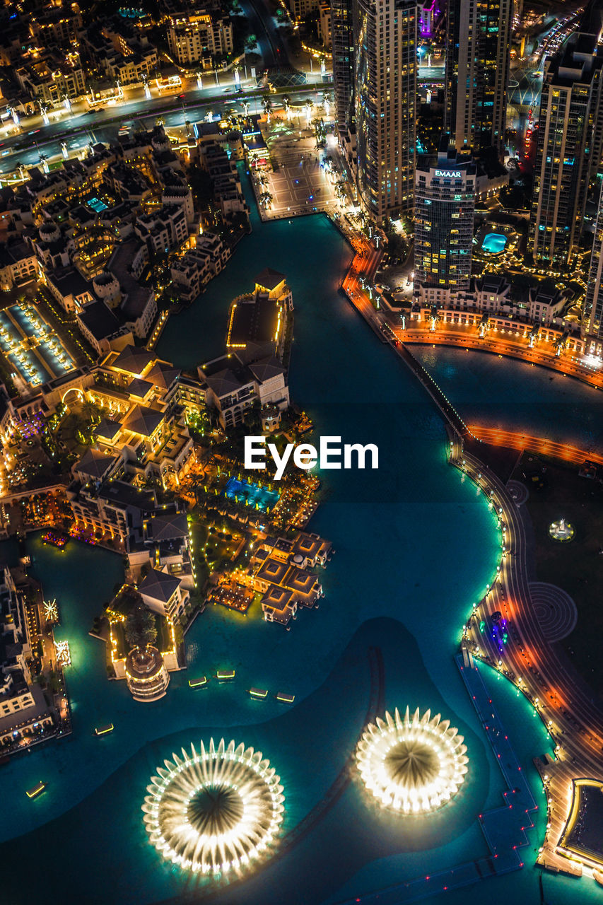 HIGH ANGLE VIEW OF ILLUMINATED CITY BUILDINGS