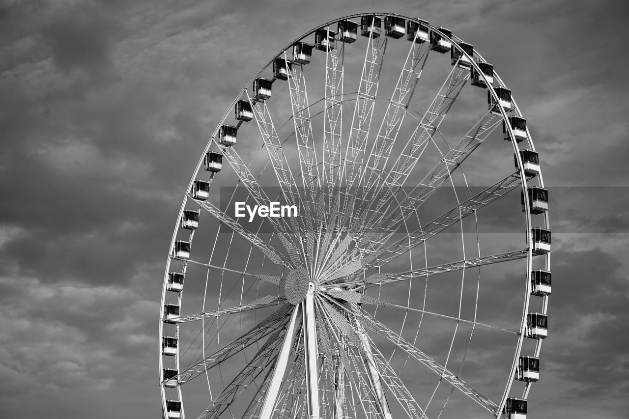 Low angle view of ferris wheel against sky