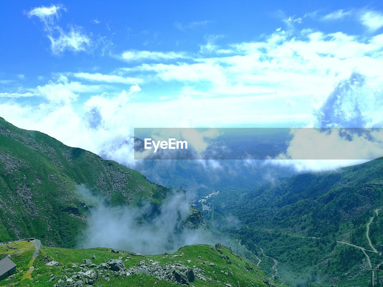 Scenic view of waterfall against sky