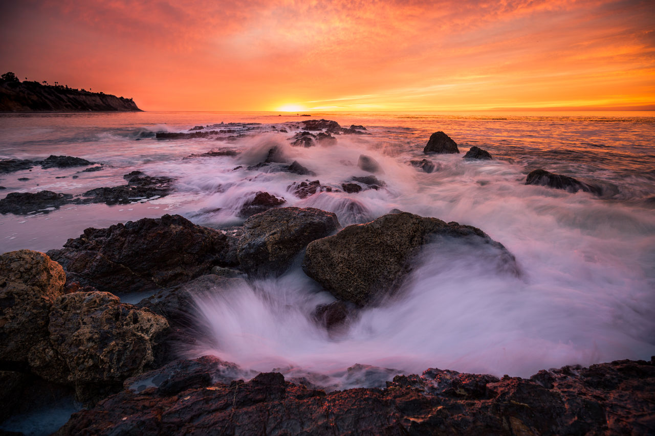 Scenic view of sea against sky at sunset