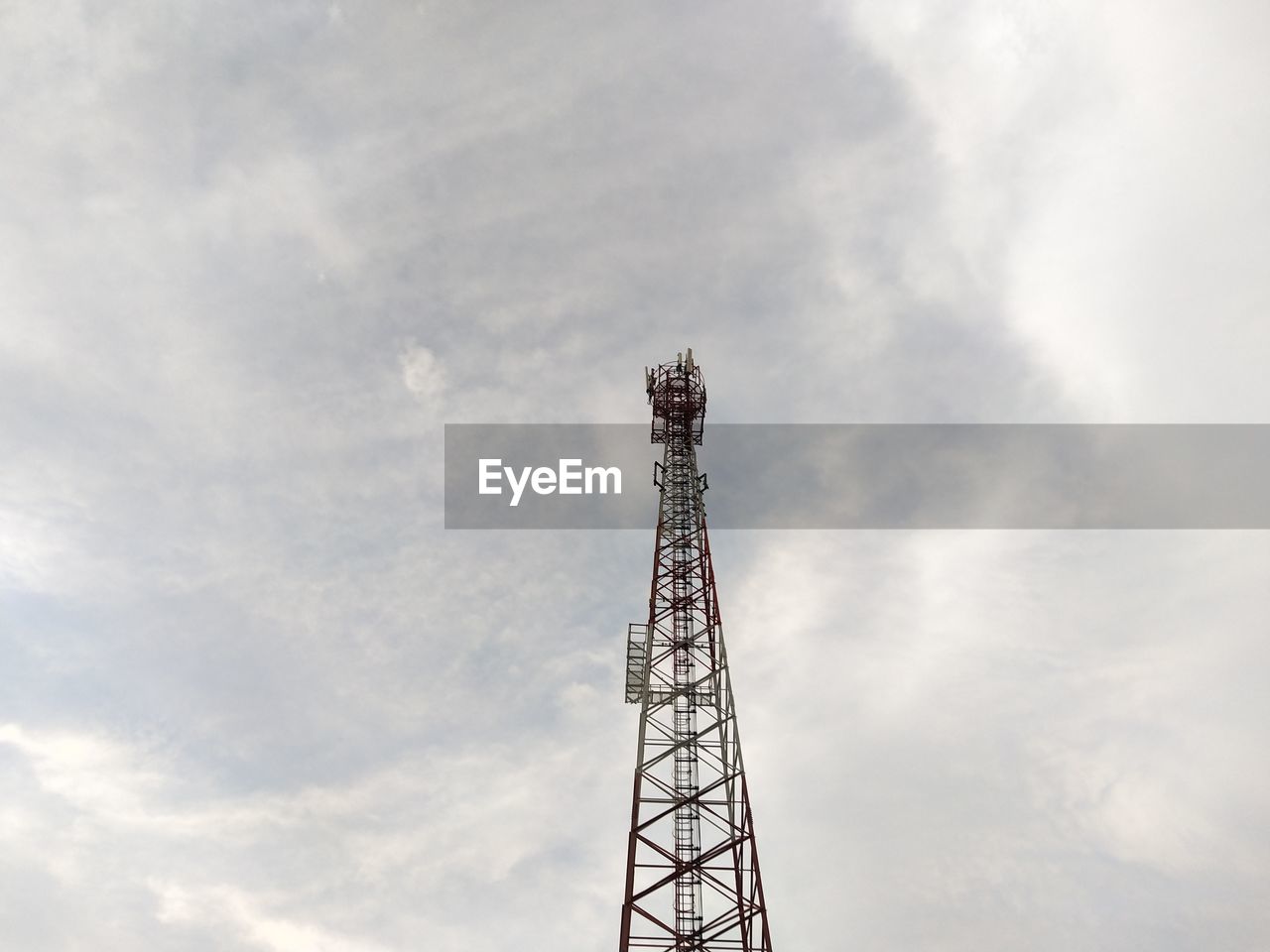 Low angle view of communications tower against sky