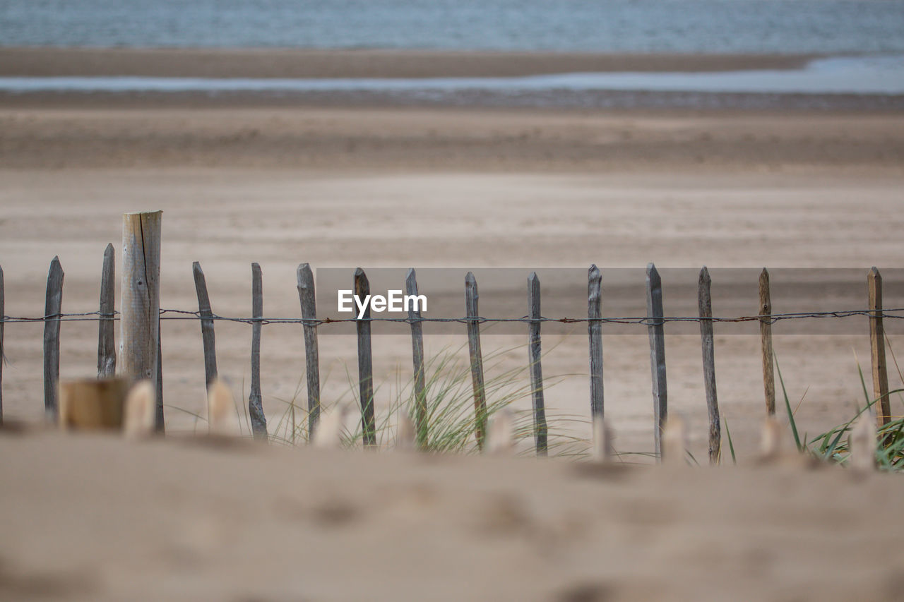 WOODEN POSTS AGAINST SKY