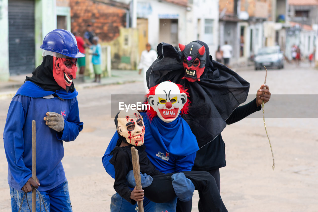 Unidentified people are seen wearing horror costumes and masks in the acupe district 