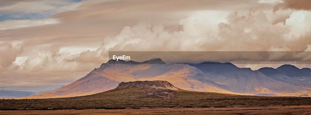 Rocky landscape against cloudy sky