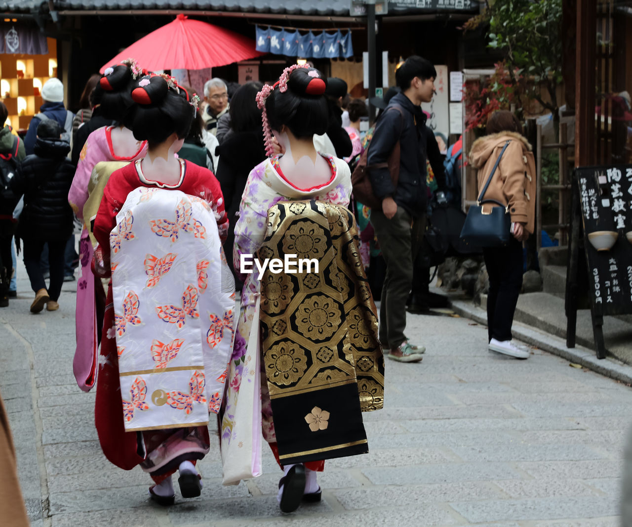 GROUP OF PEOPLE WALKING ON STREET