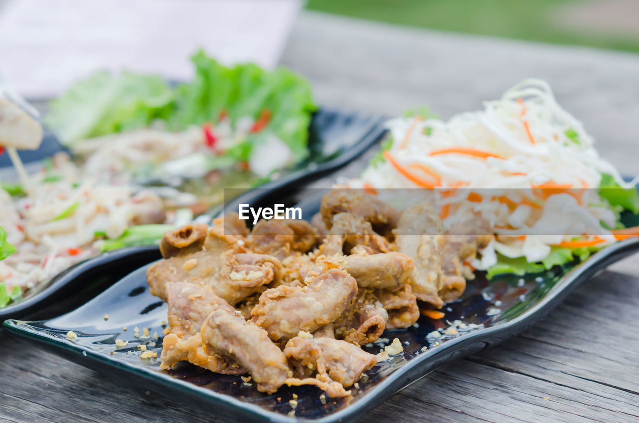 CLOSE-UP OF SERVED FOOD ON TABLE