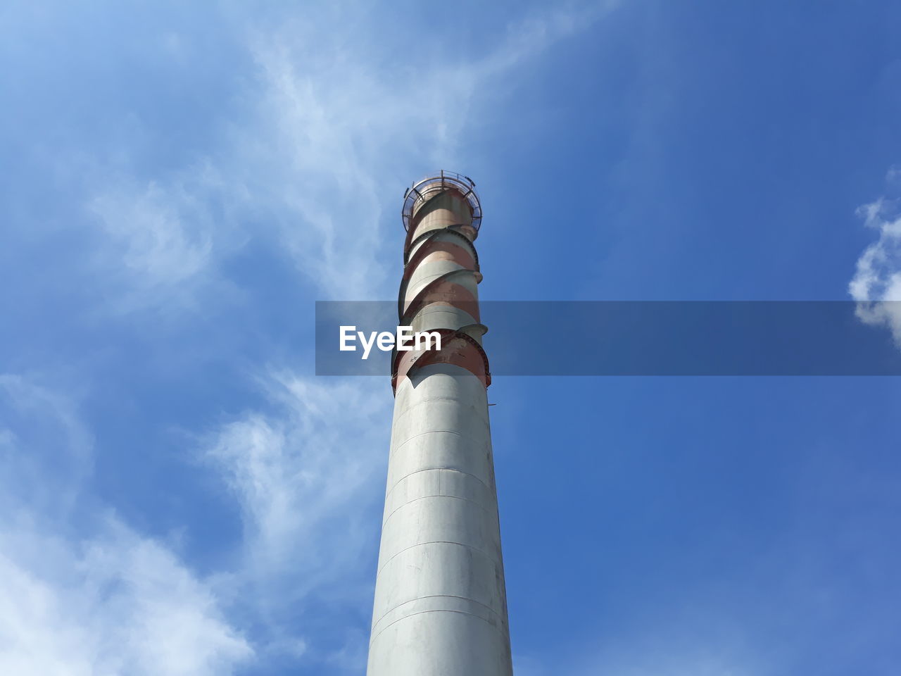 Low angle view of smoke stack against sky