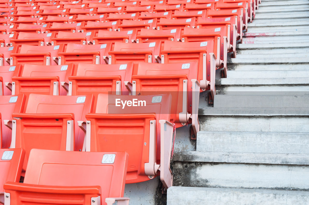 Empty orange seats at stadium,rows of seat on a soccer stadium