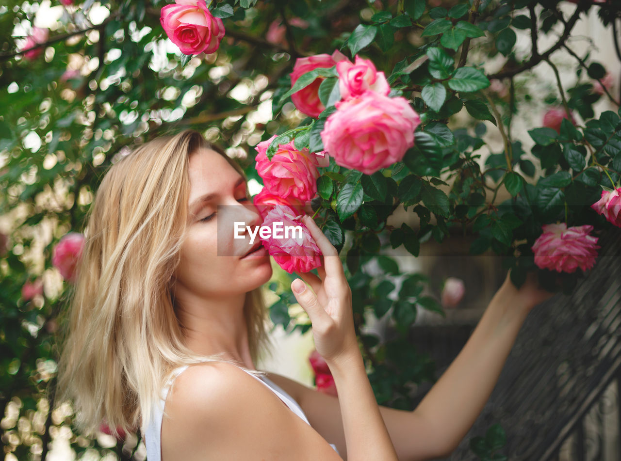 Portrait of woman with pink flower