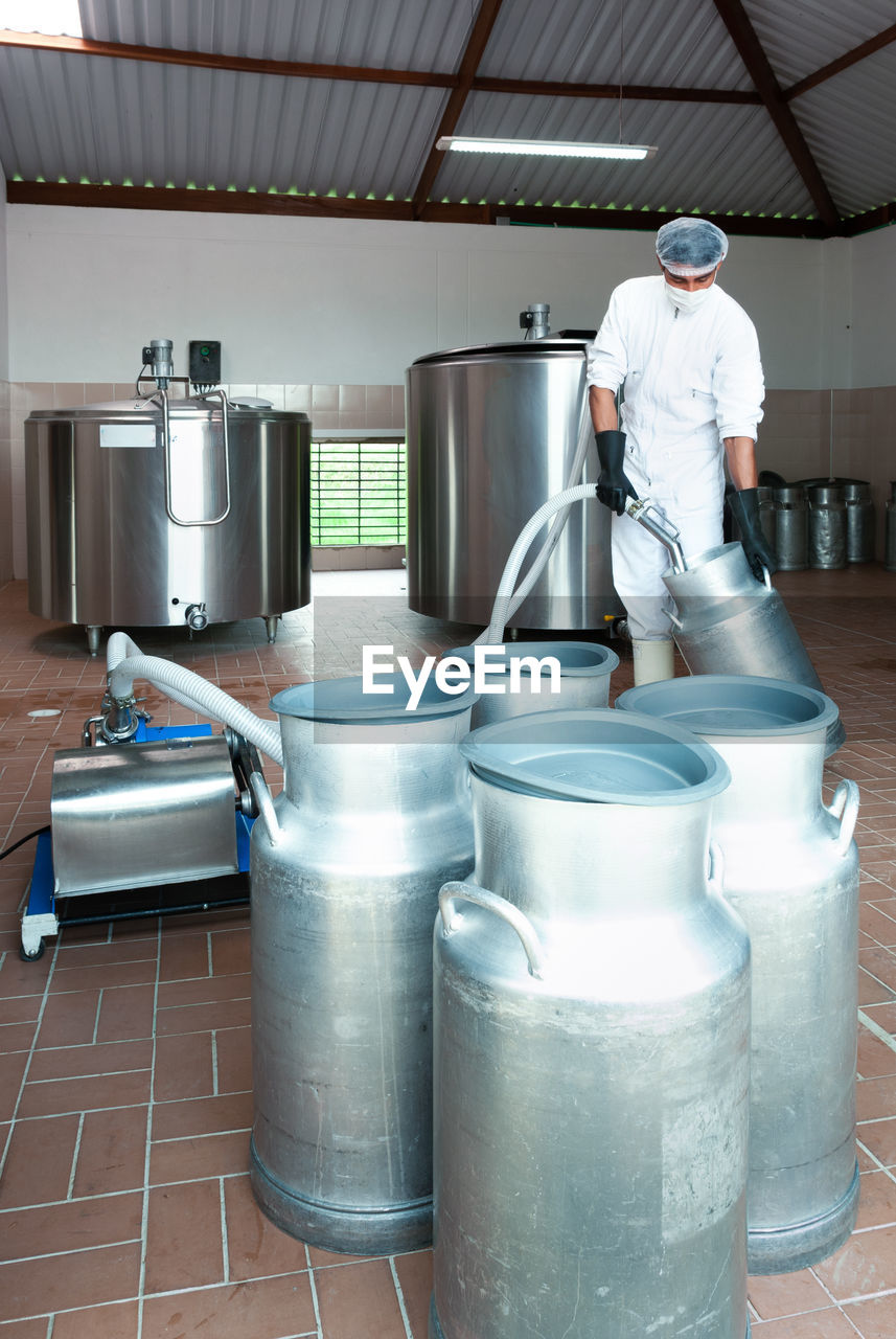 FULL LENGTH OF MAN WORKING IN KITCHEN