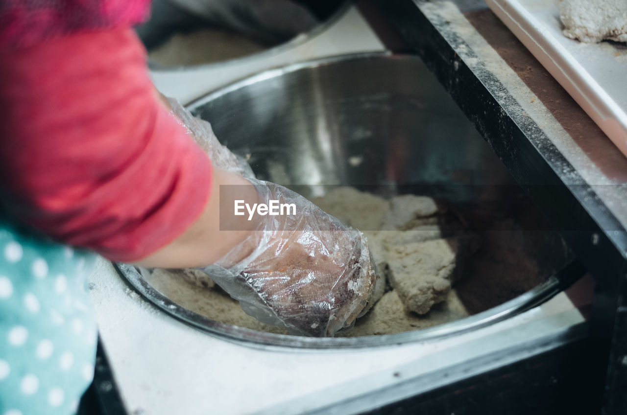 Cropped hand of person preparing food