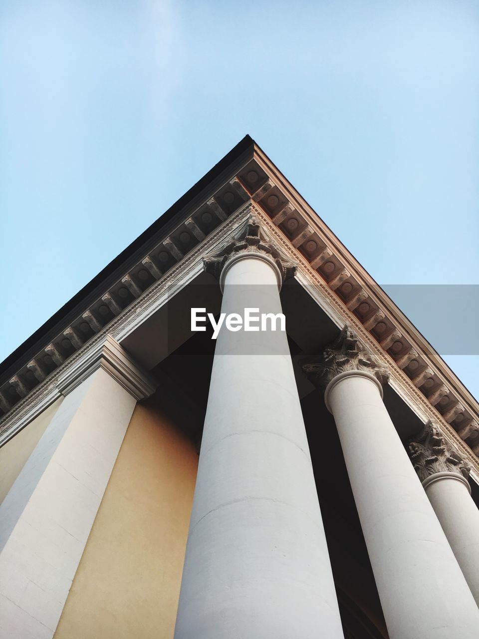 Low angle view of colonnade against sky