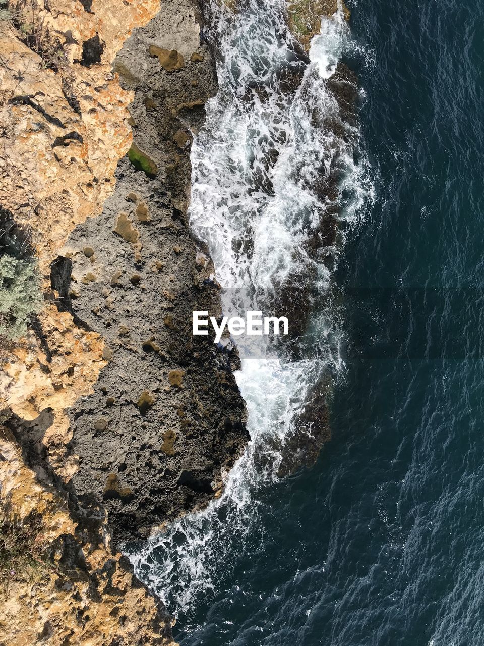 Aerial view of rock formation at sea