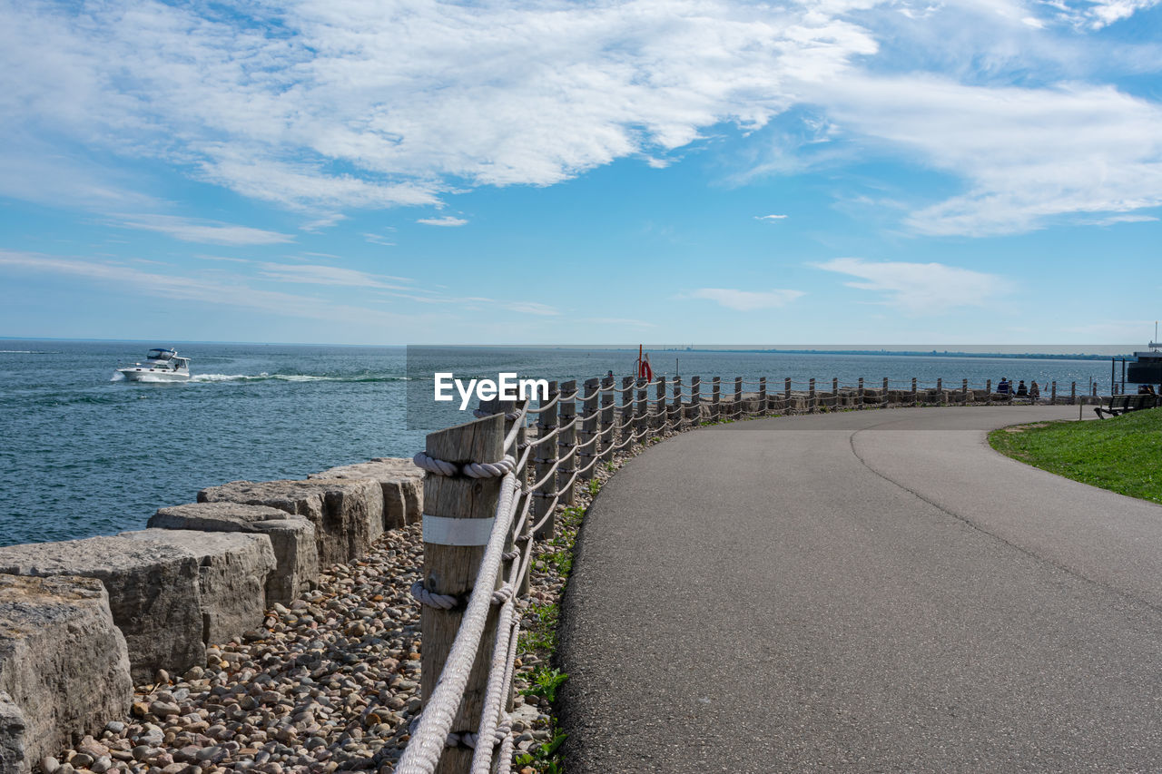 Panoramic view of road by sea against sky