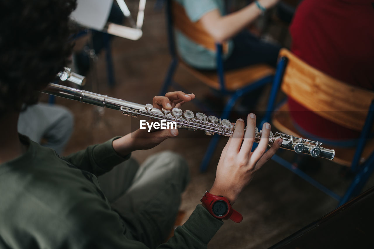 High angle view of man playing flute