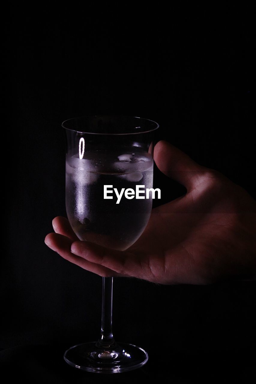 Cropped image of person holding wineglass