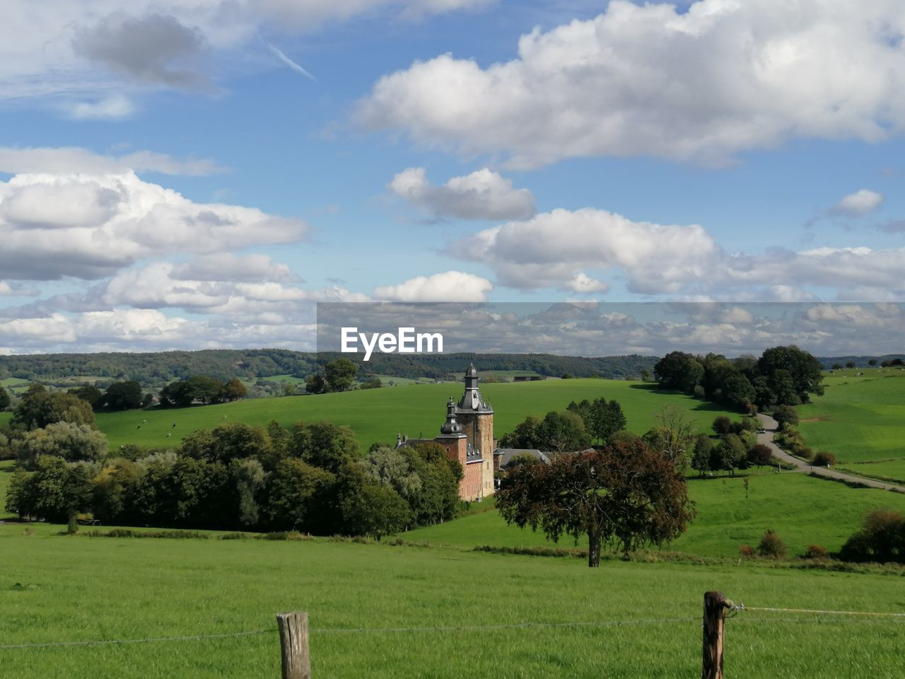 plant, sky, cloud, landscape, grass, hill, environment, field, rural area, pasture, nature, plain, land, meadow, green, agriculture, tree, scenics - nature, grassland, rural scene, beauty in nature, prairie, farm, tranquility, architecture, no people, tranquil scene, day, horizon, outdoors, non-urban scene, travel destinations, building, built structure, religion, growth, history, fence, travel, idyllic, tourism, the past