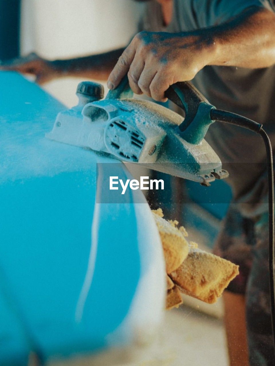 cropped hand of man working on table