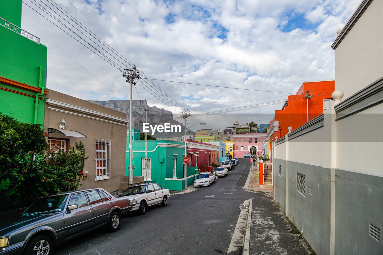 Street amidst buildings in city against sky