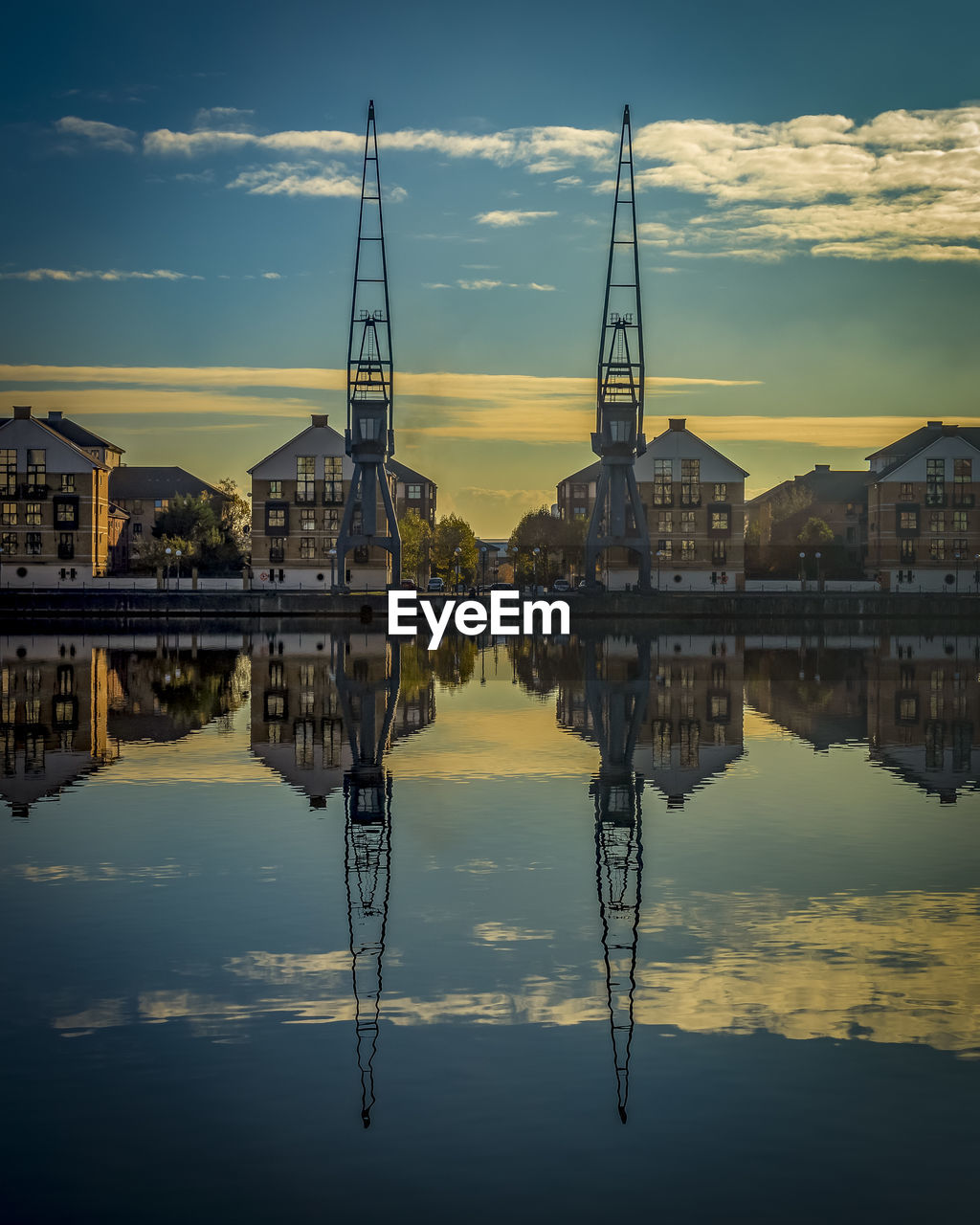 Reflection of buildings in water during sunset