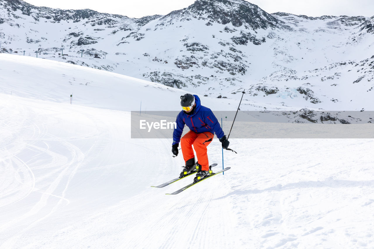 Man skiing on snow covered land