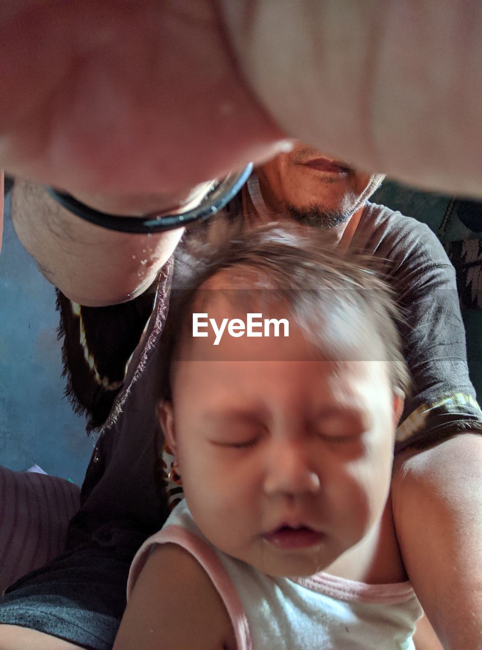 CLOSE-UP PORTRAIT OF CUTE BABY WITH EYES CLOSED