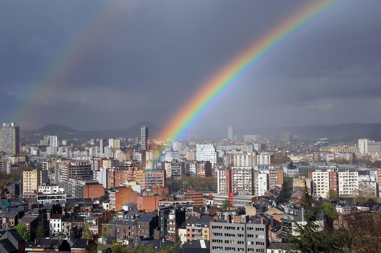 High angle shot of townscape against rainbow