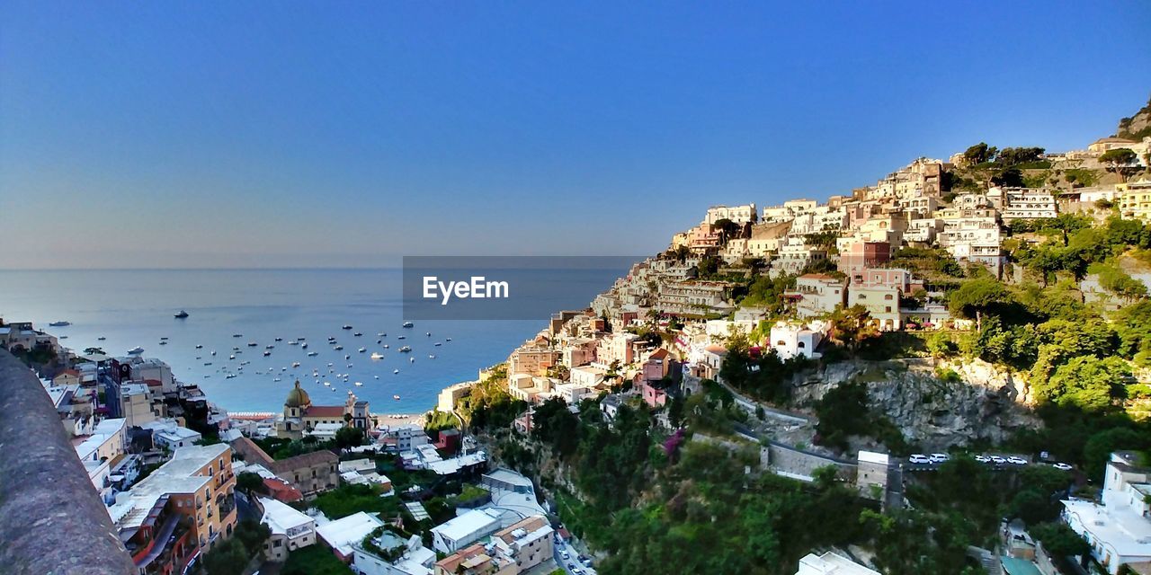 Panoramic view of sea against clear blue sky