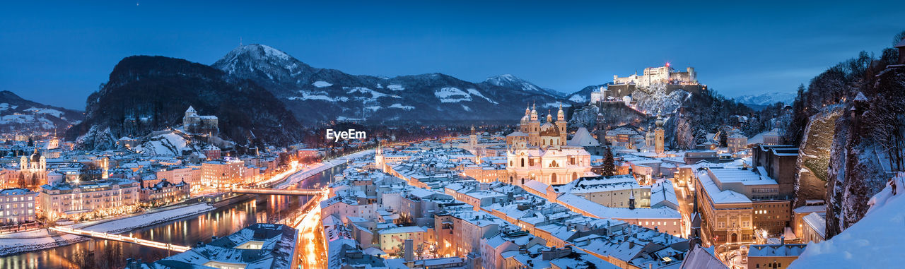 Panoramic view of illuminated cityscape at dusk