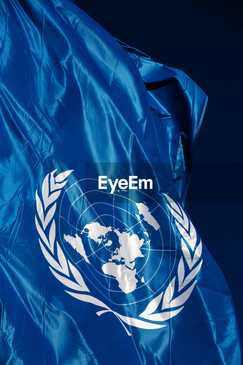 Close-up of united nations flag against black background