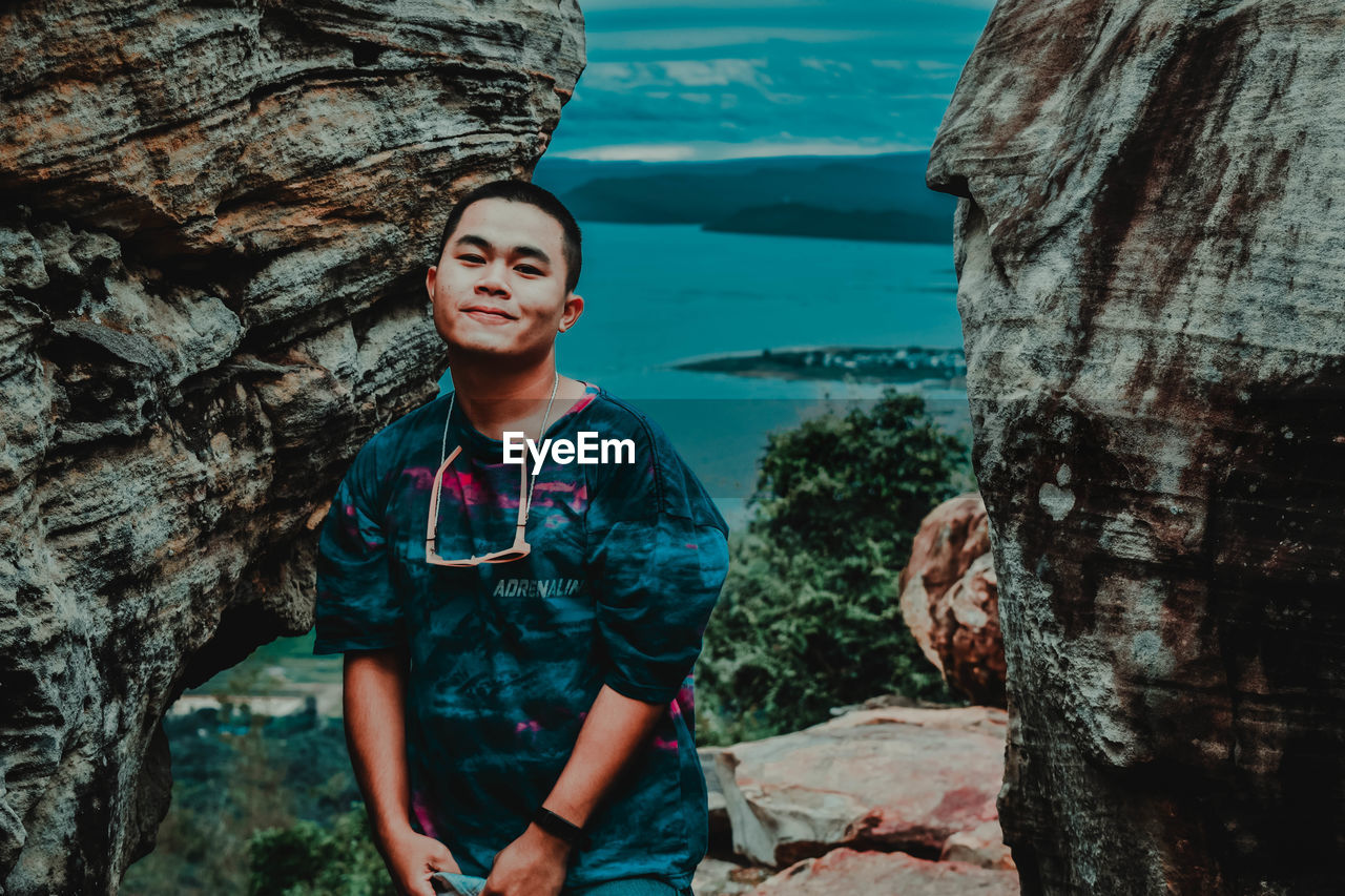 Young man standing on rock